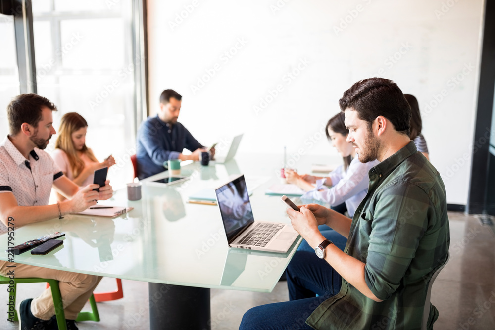 Business people in meeting room ignoring their work Business people in meeting room ignoring their work