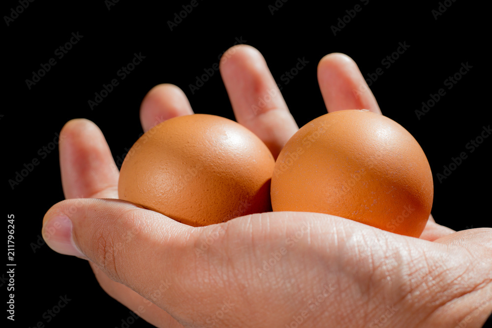Eggs in hand, black background, food organic Eggs in hand, black background, food organic