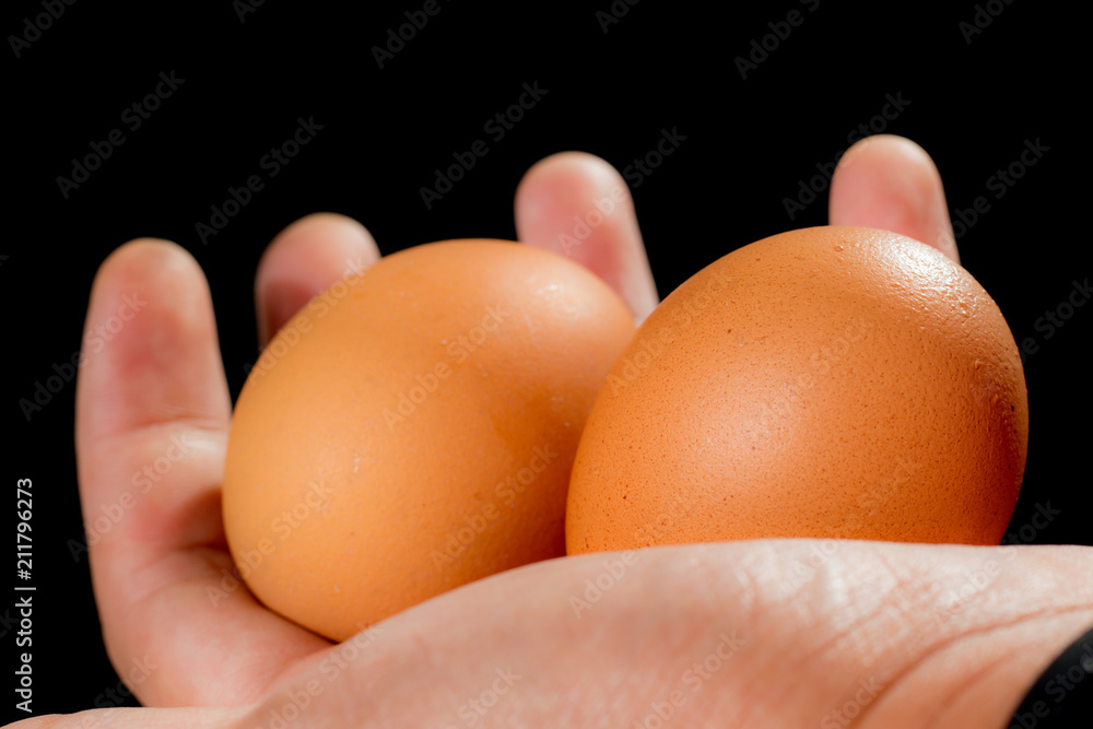 Eggs in hand, black background, food organic Eggs in hand, black background, food organic