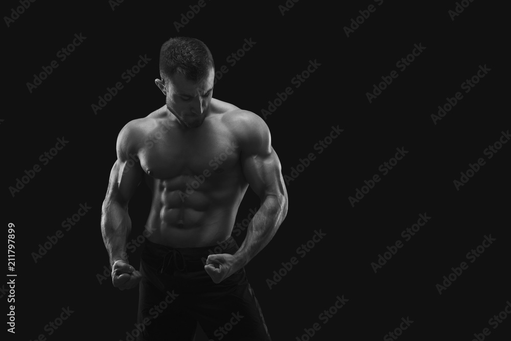 Strong athletic man showes naked muscular body Strong athletic man showes naked muscular body