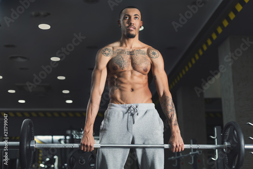 Muscular bodybuilder doing heavy deadlifts at gym © Prostock-studio