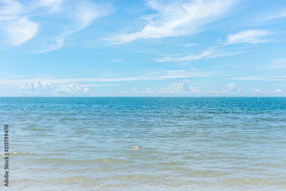 Empty beautiful sea water ocean on sandy tropical beach and blue sky clouds background. copy space
