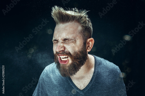 Man sneezing indoors