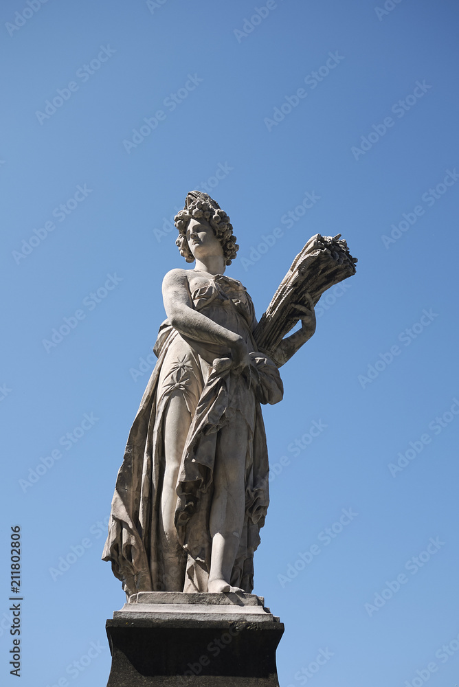 Firenze, Italy - June 21, 2018 : Statue of Summer by Giovanni Caccini at Ponte Santa Trinita (Holy Trinity Bridge), the oldest elliptic arch bridge in the world.