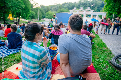 Fényképezés people watching movie in open air cinema in city park