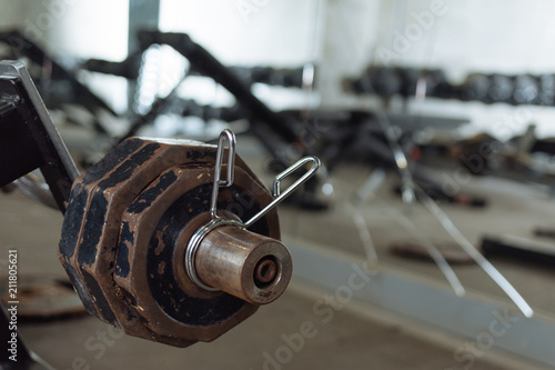 Disassembled barbell on floor in gym.Sports equipment. diverse equipment and machines at the gym room