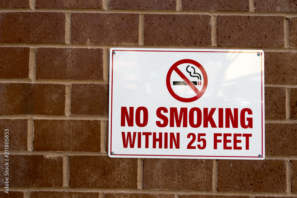 Red and white sign and icon no smoking, brick wall Red and white sign and icon no smoking, brick wall