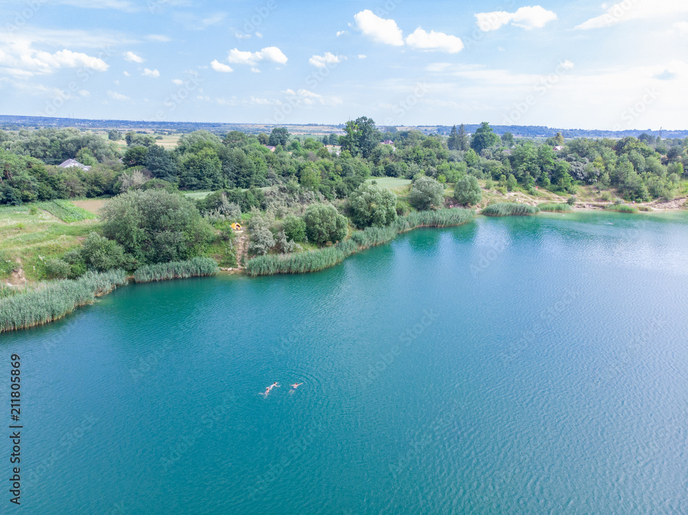 aerial view of lake with blue water and sand beaches