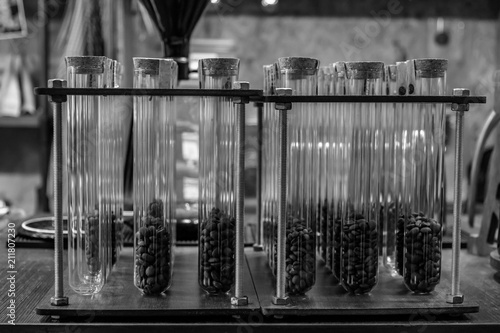 coffee beans in test tube in black and white