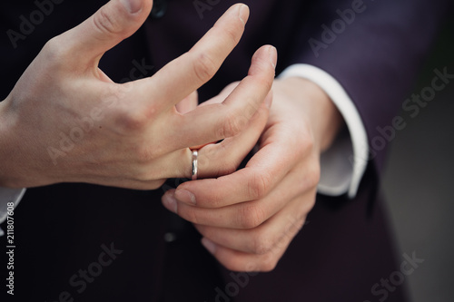 a man's hands with an engagement ring