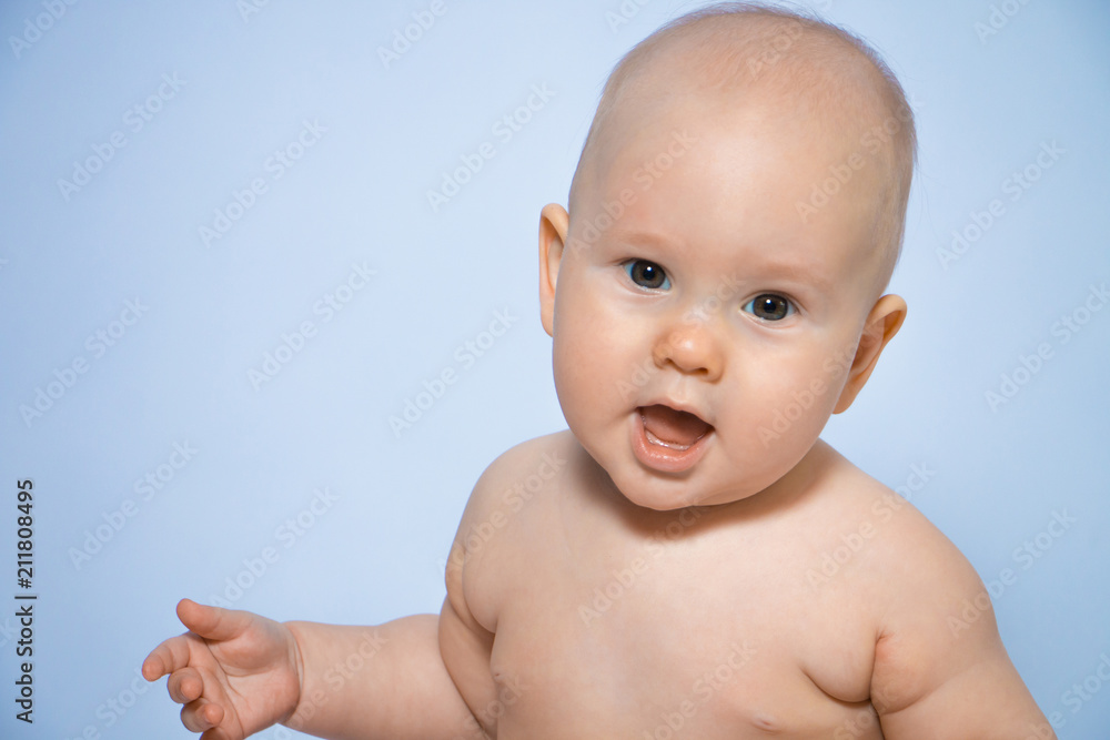 Beautiful close-up portrait of a happy baby on a uniform background Beautiful close-up portrait of a happy baby on a uniform background