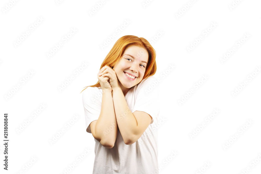 Beautiful redheaded young woman with satisfied facial expression, isolated on white background. Attractive female with natural red hair & brown eyes showing sincere smile & perfect teeth. Copy space.