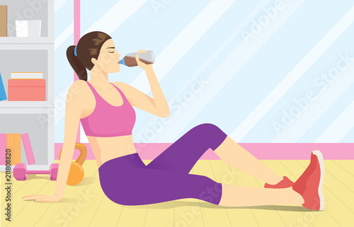 Woman drinking whey protein from bottle at gym after workout.