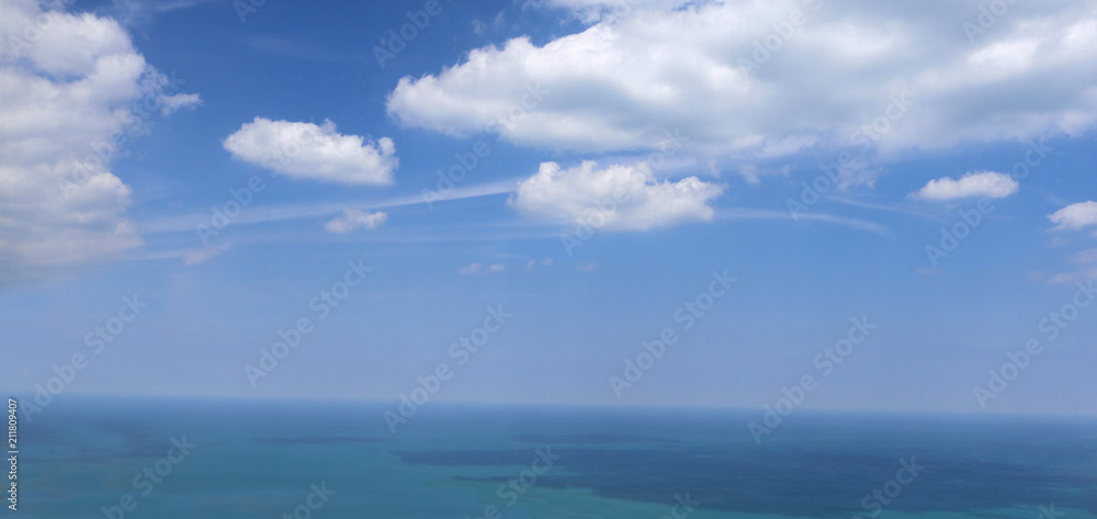 white clouds on beautiful sunny day with large lake or ocean white clouds on beautiful sunny day with large lake or ocean