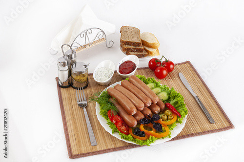 Boiled sausages with tomatoes, cucumbers and greens. Served with black or white bread.