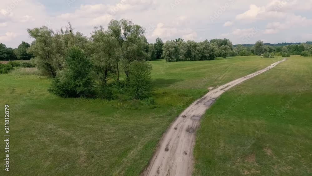 flight over the dirt road in the forest and meadow. flight over the dirt road in the forest and meadow.