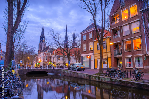 Evening view of the canal and the church in Delft. Dutch city in the spring after sunset. Holland  Netherlands.