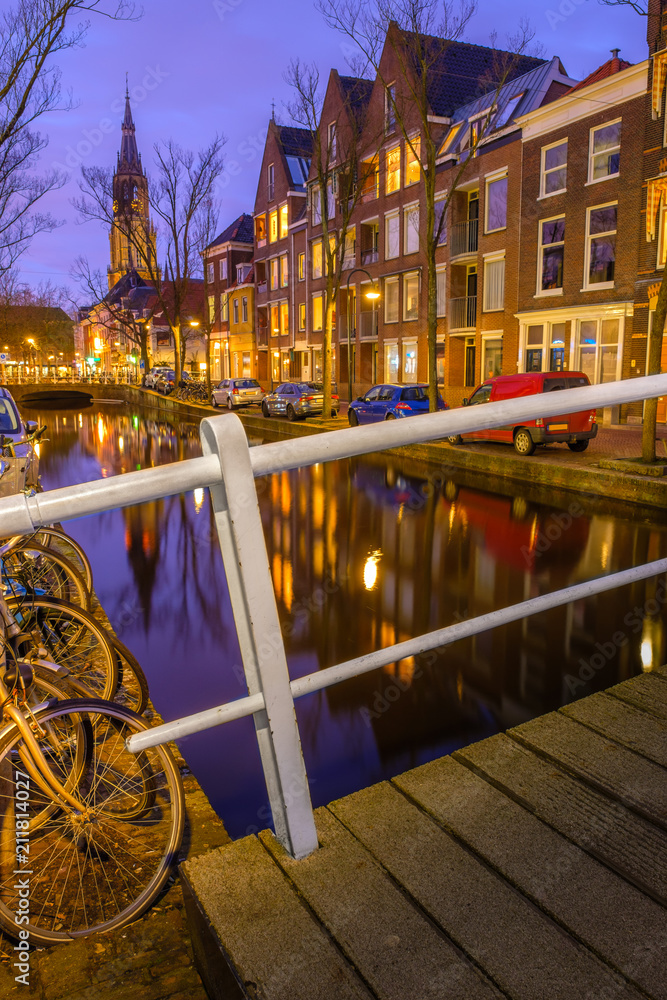 Fototapeta premium Evening view of the canal and the church in Delft. Dutch city in the spring after sunset. Holland, Netherlands.