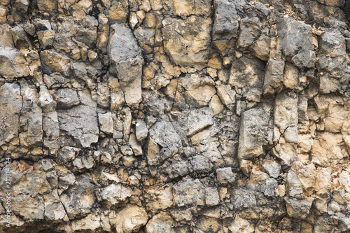 Textured stone background Rubble ballast in natural form in the rock wall