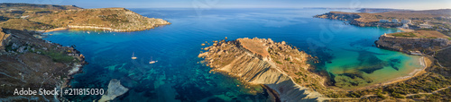 Ghajn Tuffieha, Malta - Aerial panoramic view of the coast of Ghajn Tuffieha with Gnejna Bay, Riviera Bay and Golden Bay at sunrise