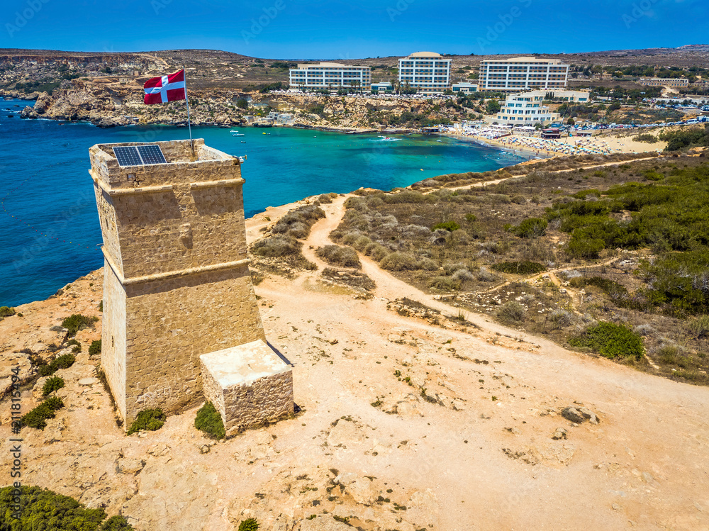 Ghajn Tuffieha, Malta - Beautiful Ghajn Tuffieha Watch Tower and Golden Bay beach from above on a bright summer day with clear blue sky