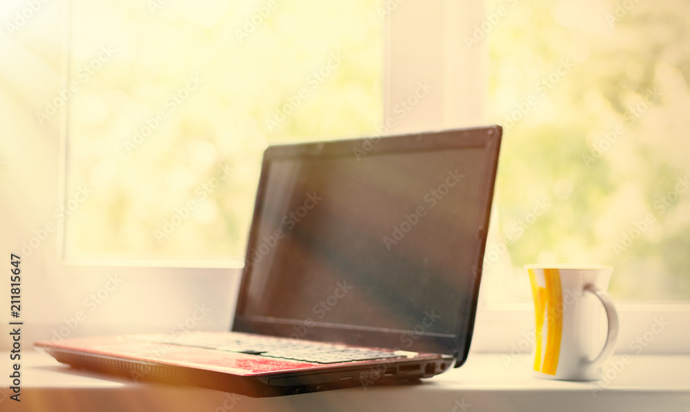 Fototapeta premium Coffee and laptop. The concept of freelancing, preparation for work, a break. Toned.