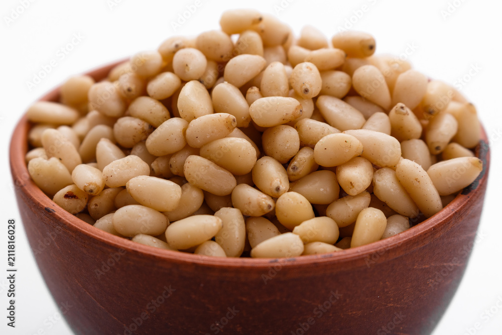 peeled pine nuts on a white acrylic background peeled pine nuts on a white acrylic background