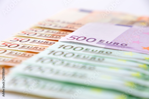 Euro banknotes close up. Several hundred euro banknotes on white background