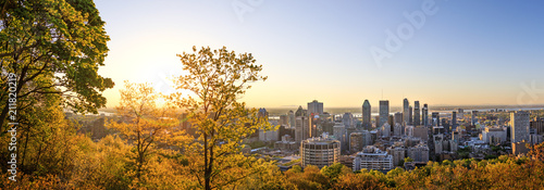 Montreal, Canada – 21 May 2018. Beautiful golden sunrise over the Montreal city. Amazing panorama of Montreal downtown skyline in the morning hours. Golden sun light view from Mont-Royal park. photo