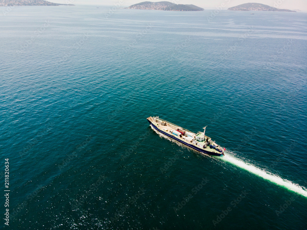 Aerial Drone View of Cargo Ship Carry Vehicles to the Island.