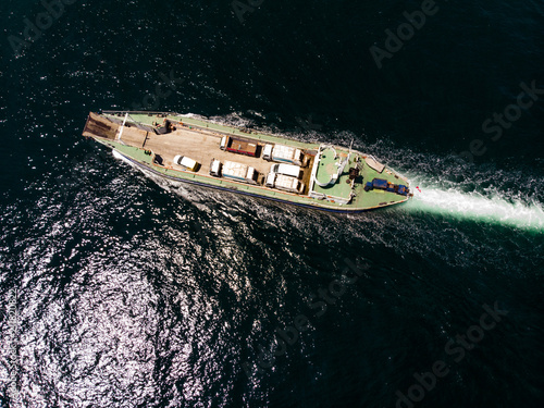 Aerial Drone View of Cargo Ship Carry Vehicles to the Island. © Alp Aksoy