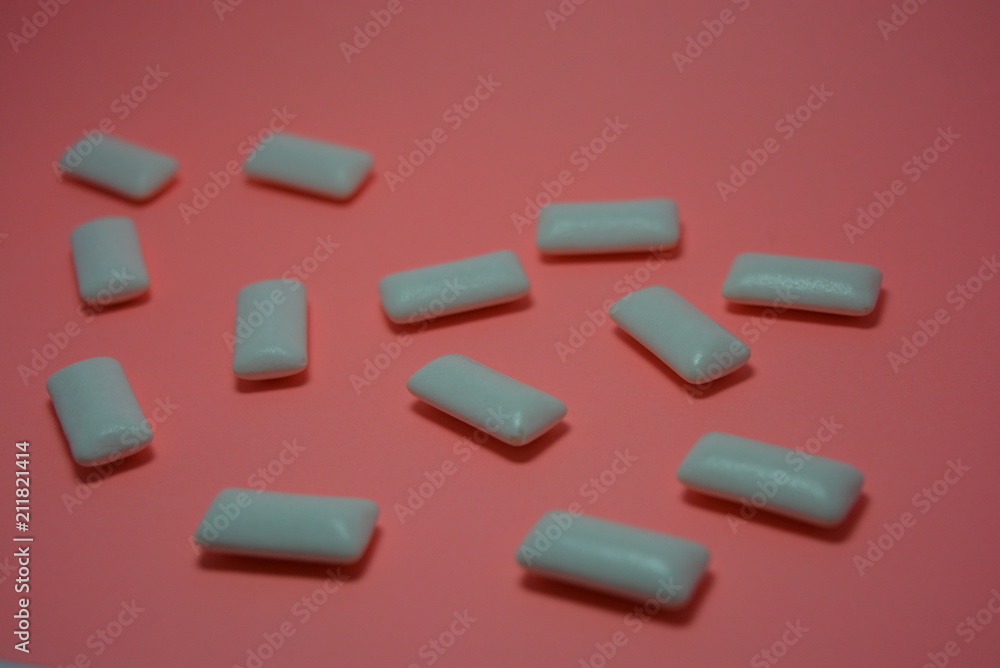 On the charcoal, peach paper are white cushions from chewing gum On the charcoal, peach paper are white cushions from chewing gum