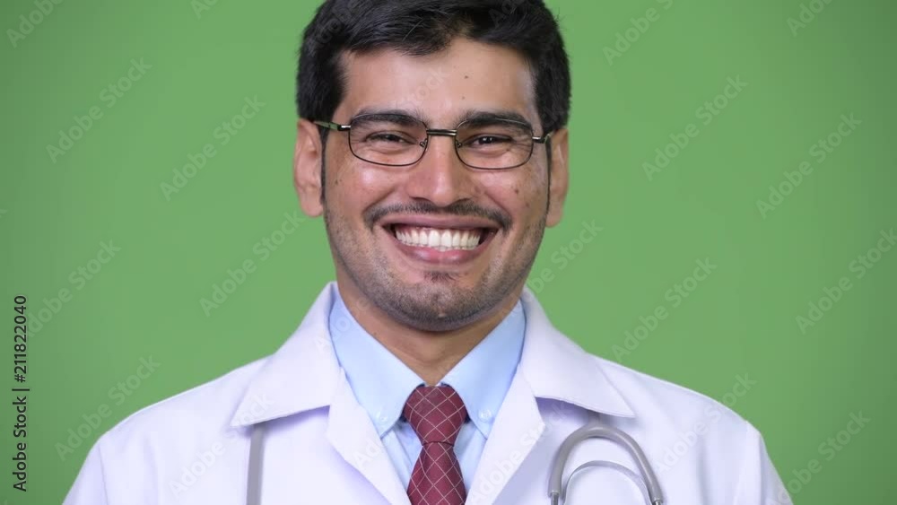 Young handsome Persian man doctor smiling Young handsome Persian man doctor smiling