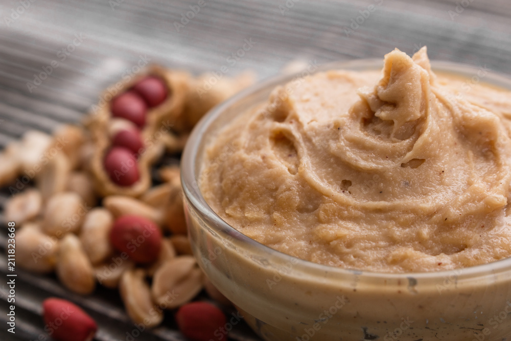 Fototapeta premium peanut paste on a wooden rustic background
