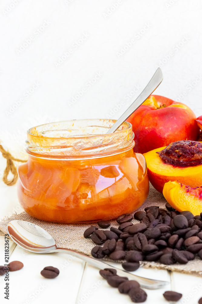 Nectarine jam confiture in ramekin and jar. Dark background. Selective focus. Close up. Nectarine jam confiture in ramekin and jar. Dark background. Selective focus. Close up.