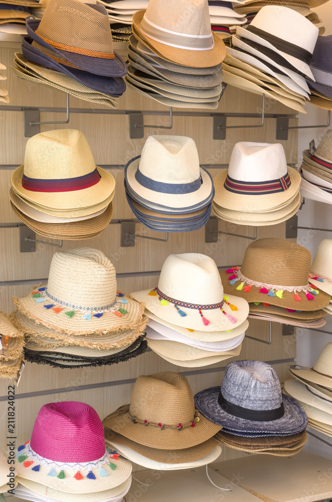 Many summer straw hats in shop