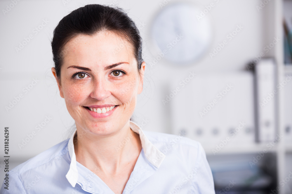 Cheerful businesswoman in shirt at workplace