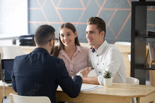Fényképezés Insurance agent or broker consulting smiling millennial couple on property purch