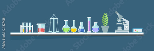 Glassware, jars, flasks, tubes, complex installation systems in working cabinet.
