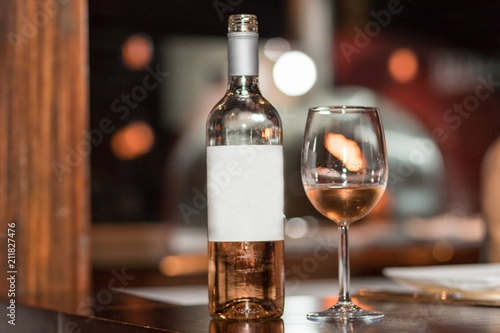Bottle of rose wine and glass served with rose wine