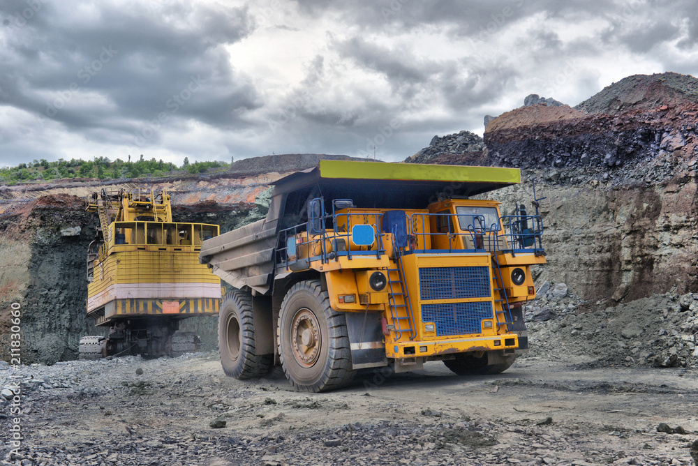 Large quarry dump truck. Loading the rock in the dumper. Loading coal into body work truck Large quarry dump truck. Loading the rock in the dumper. Loading coal into body work truck