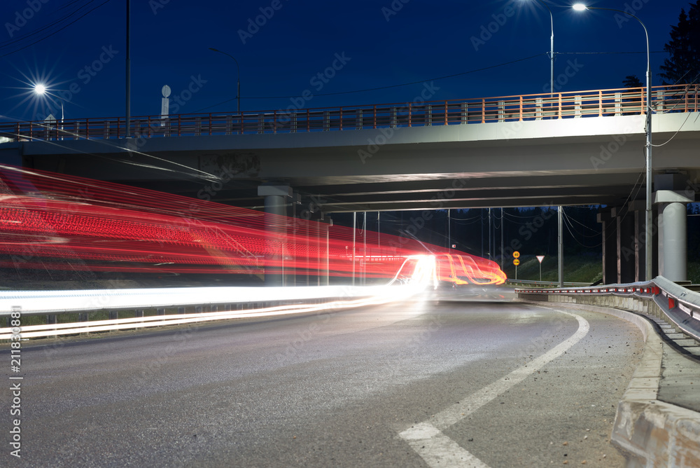 Large city road night scene, night car light trails. Road and highway overpass or viaduct