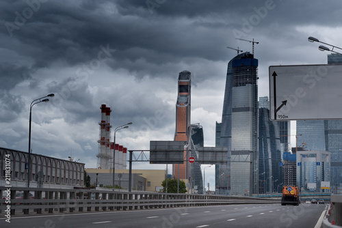 complicated highway intersection with modern city skyline at cloudy day in moscow russia, road transportation infrastructure.