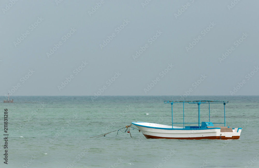 A fishing boat at Busaiteen beach, Bahrain A fishing boat at Busaiteen beach, Bahrain