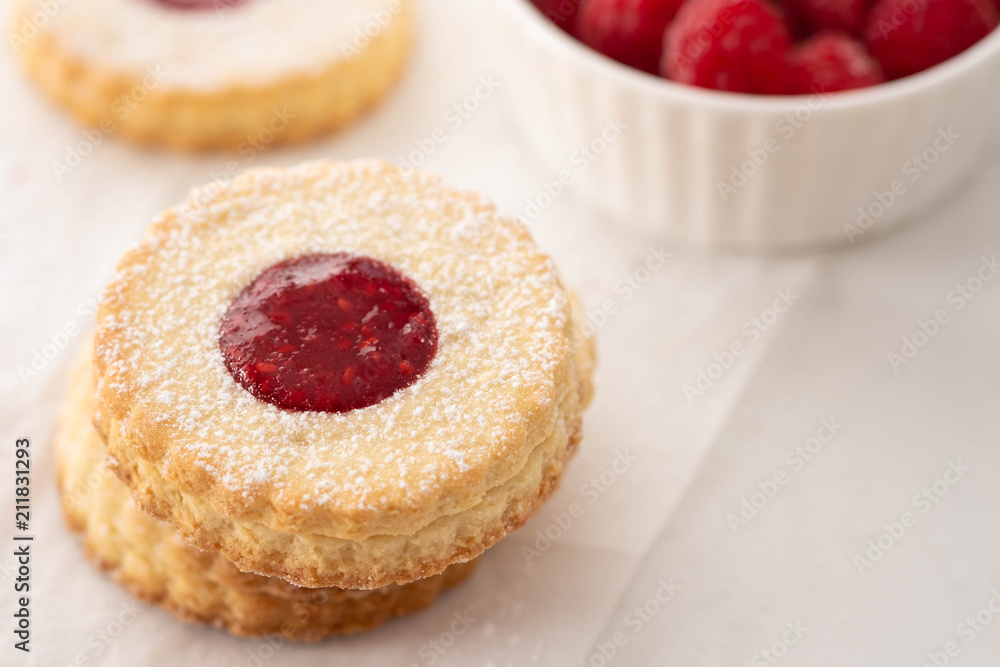 Traditional Christmas Linzer cookies with sweet jam on plate, closeup, copy space. Traditional Christmas Linzer cookies with sweet jam on plate, closeup, copy space.