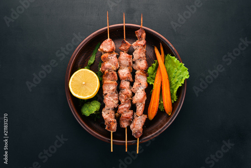 Tableau sur toile Baked Skewers of meat on a plate