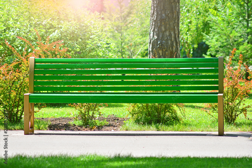 Front view of an empty green bench in the park Front view of an empty green bench in the park