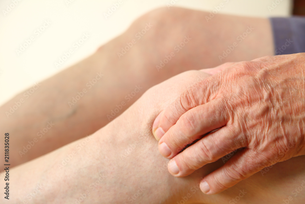 Fototapeta premium Closeup man with hand on his knee