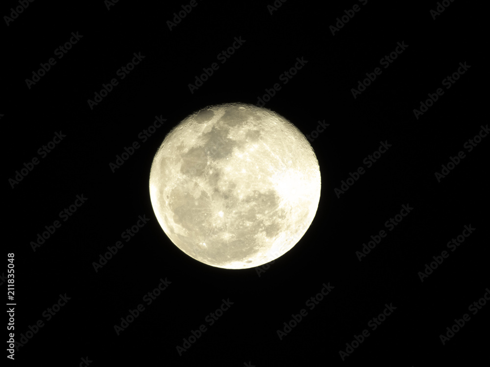 Moon in the middle of its way on the clear sky.