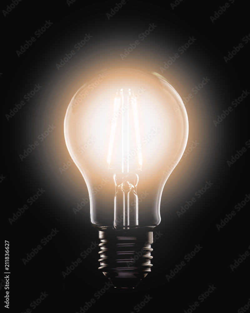 Broom Højttaler personlighed Lit LED light bulb on a black background Stock Photo | Adobe Stock
